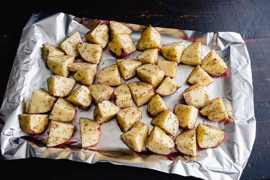 The sliced potatoes tossed in coconut oil and spices