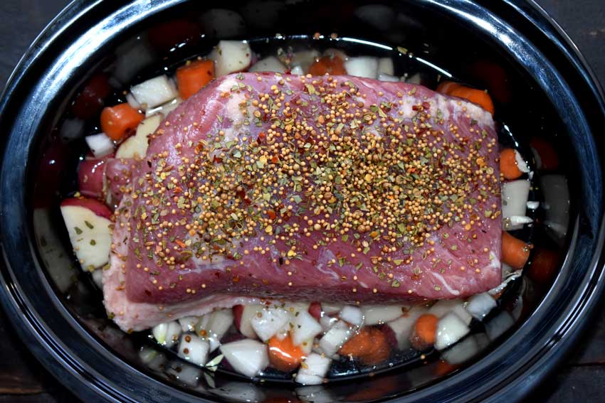 Corned beef, potatoes, onion, and carrots just added to the crockpot