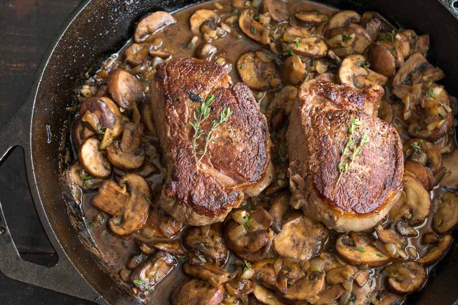 Filet mignon and mushroom sauce in a cast iron pan