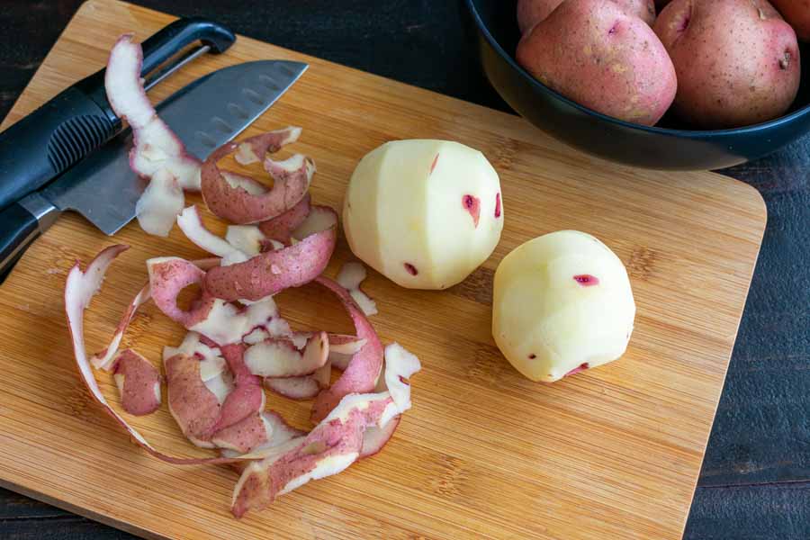 Peeling potatoes for the lentil and mushroom shepherd's pie