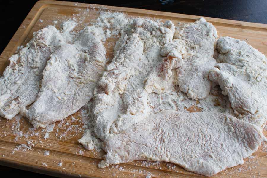 The battered chicken breasts before frying