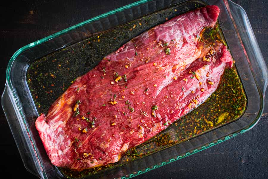 Marinating the flank steak in a shallow baking dish