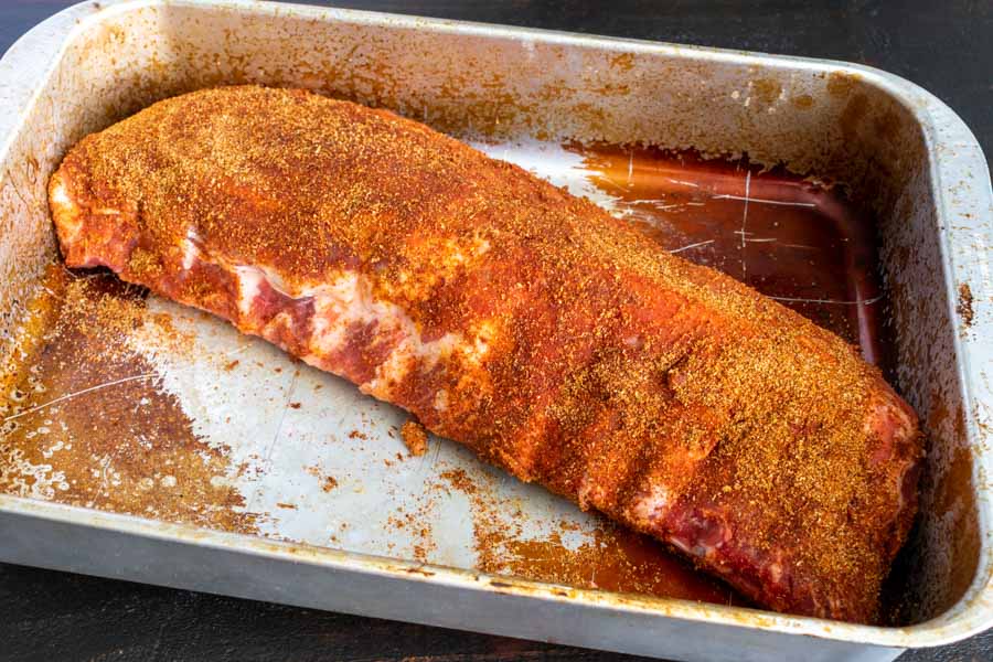 Spice rubbed rack of ribs in a baking dish