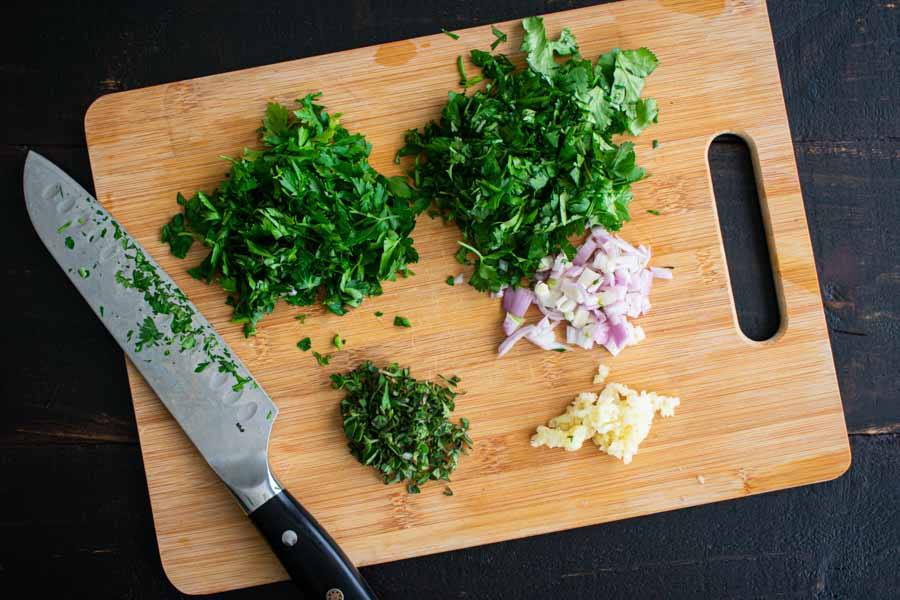 Chopped cilantro, parsley, shallot, and oregano with minced garlic