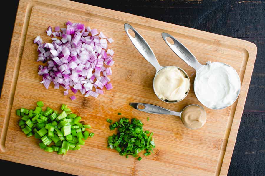 The prepped red onion, celery, scallion greens, dijon mustard, mayonnaise, and plain Greek yogurt