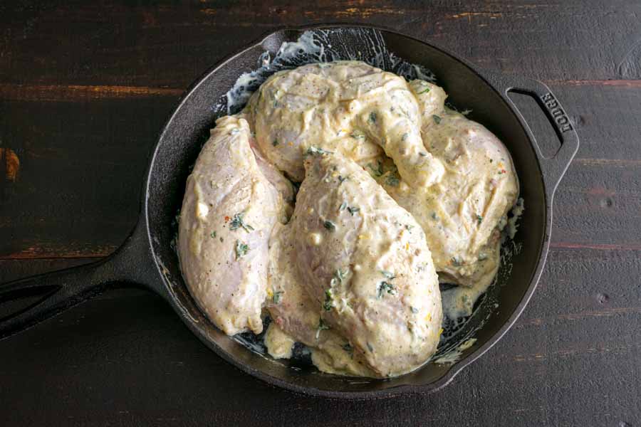 Marinated chicken in a cast-iron skillet