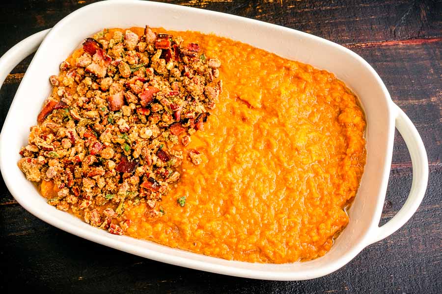 Topping the mashed sweet potatoes with the bacon-pecan mixture