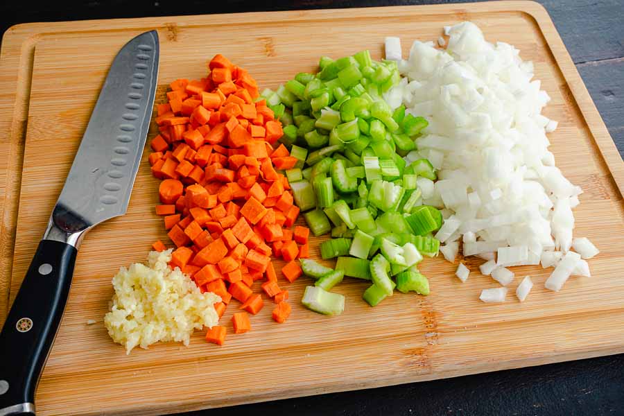 Minced garlic with finely chopped carrots, celery, and onions