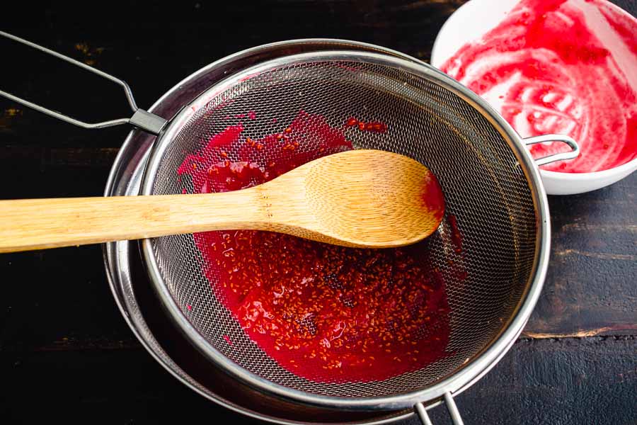 Straining the seeds out of the raspberry puree