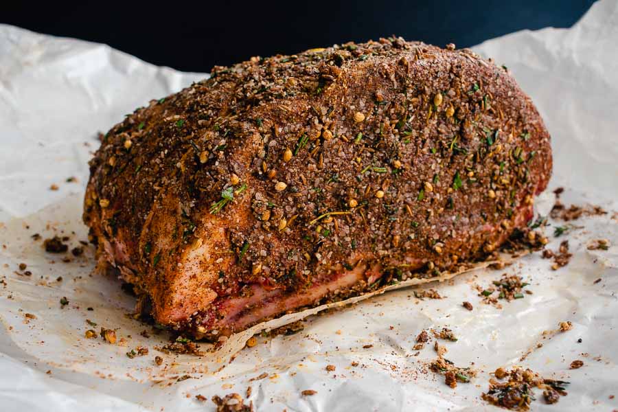 Bone-in beef rib roast coated in the dry rub made with spices and olive oil