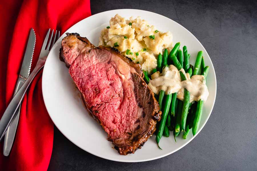 Standing Prime Rib Roast served with Dijon Tahini Green Beans and Slow Cooked Garlic Mashed Potatoes
