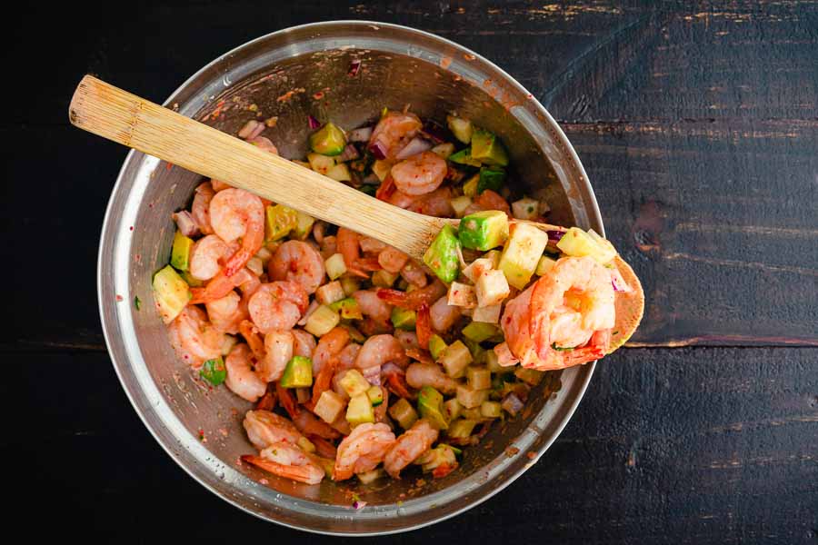Mixing the shrimp, vegetables, and dressing