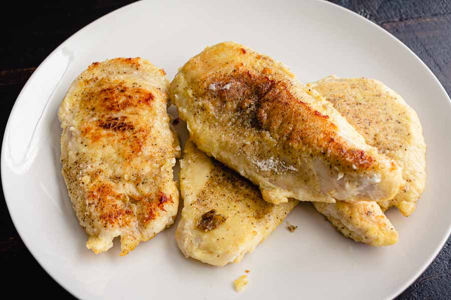 Chicken cutlets that have been seasoned, floured, and pan-fried