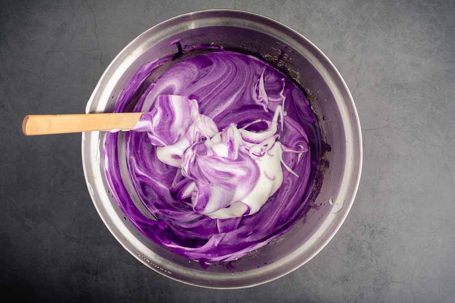 Mixing the meringue into the ube cake batter