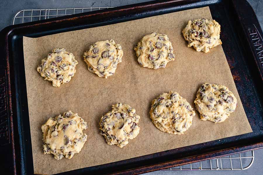 Baked Softbatch Cream Cheese Chocolate Chip Cookies on a parchment-paper lined sheet pan