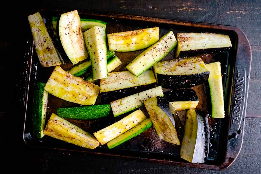Eggplant and zucchini wedges tossed in olive oil and spices