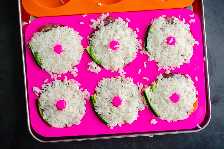 Sushi rice added to the donut mold