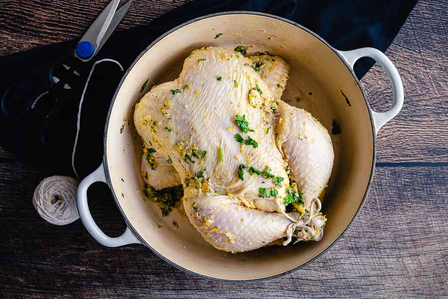 The marinated Cuban Mojo Chicken in a cast-iron Dutch oven