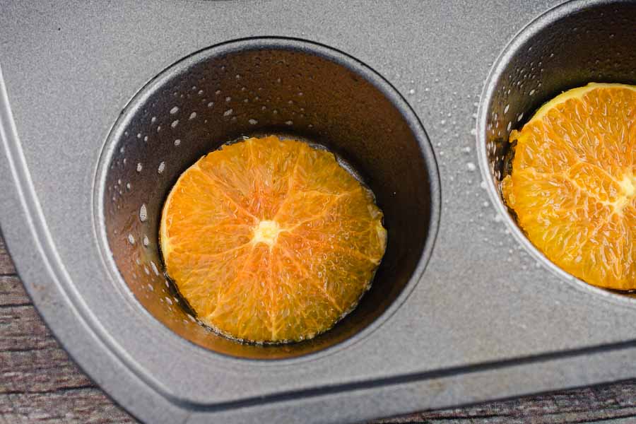 Trimmed orange slices in the muffin tin