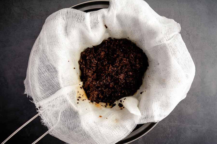 straining out the coffee grounds