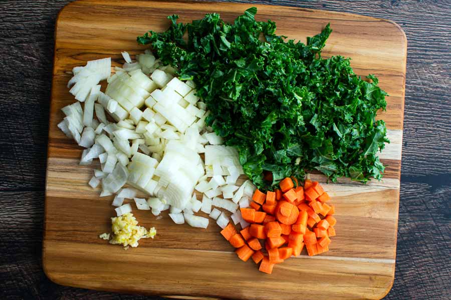 Chopped onion, kale, carrots, and garlic