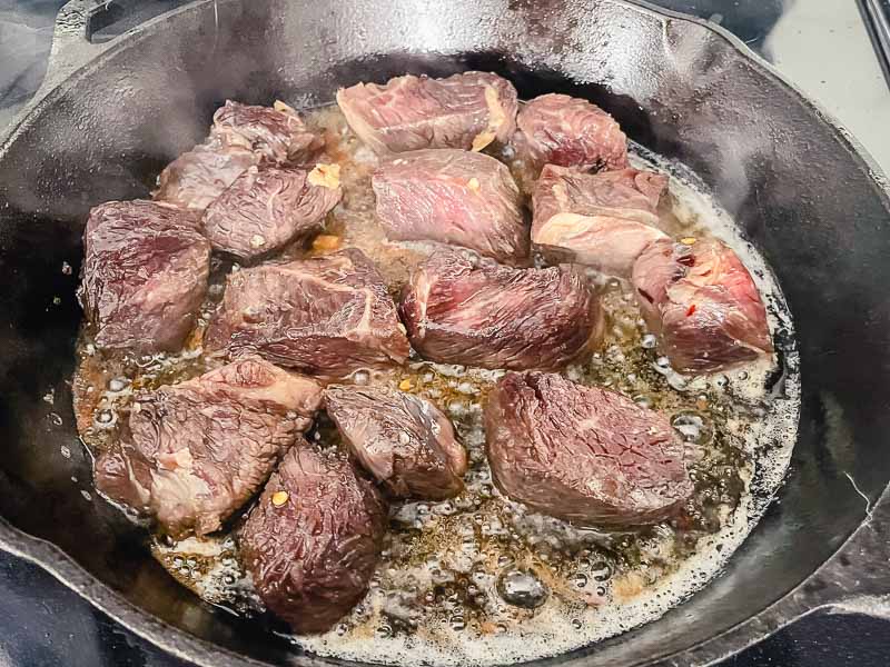 Cooking the steak tips in a cast iron skillet