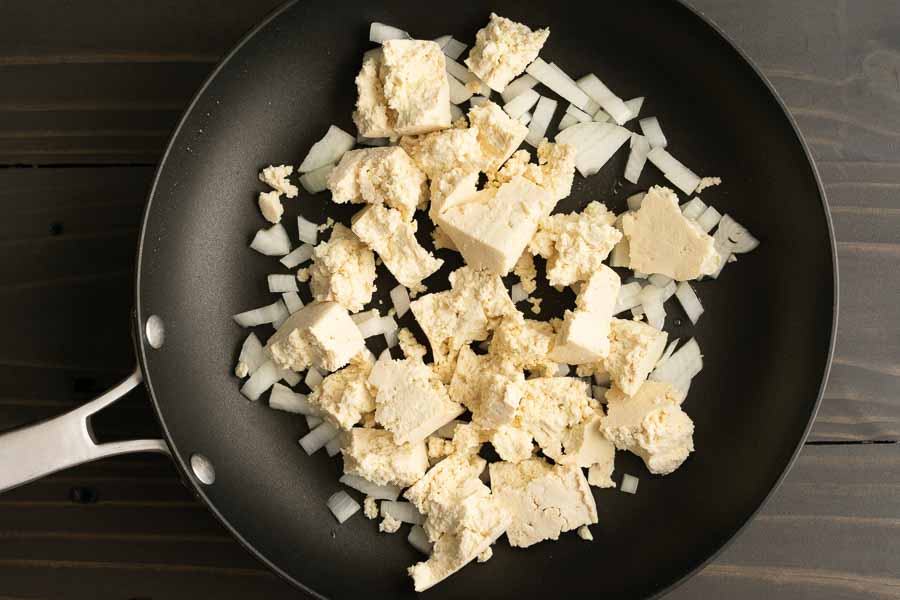 Crumbled tofu and diced onion in a 12" non-stick skillet