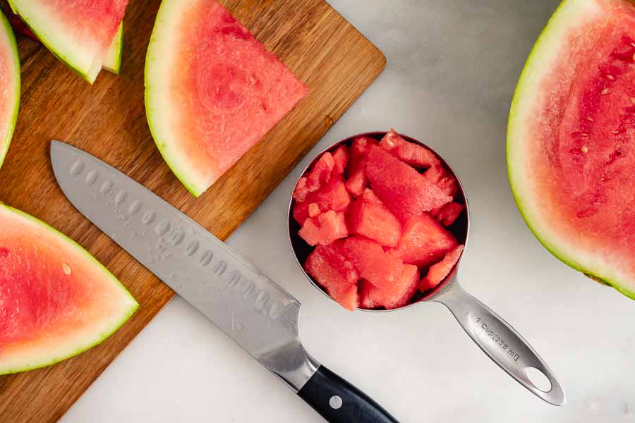 Chopping up the watermelon to make kiwi slush