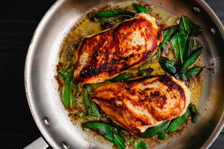 Cooking two chicken breasts in a stainless steel skillet