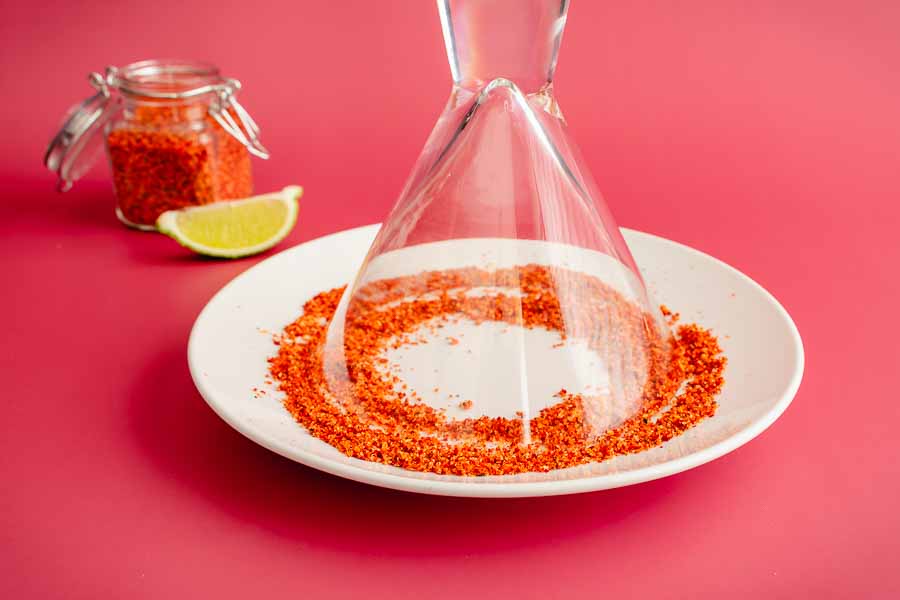 Rimming the glass with Tajin chili-lime seasoning